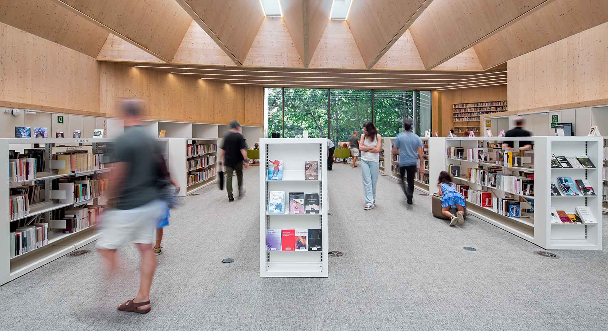 Interior of the Gabriel García Márquez public library in Barcelona, with shelves and natural light.