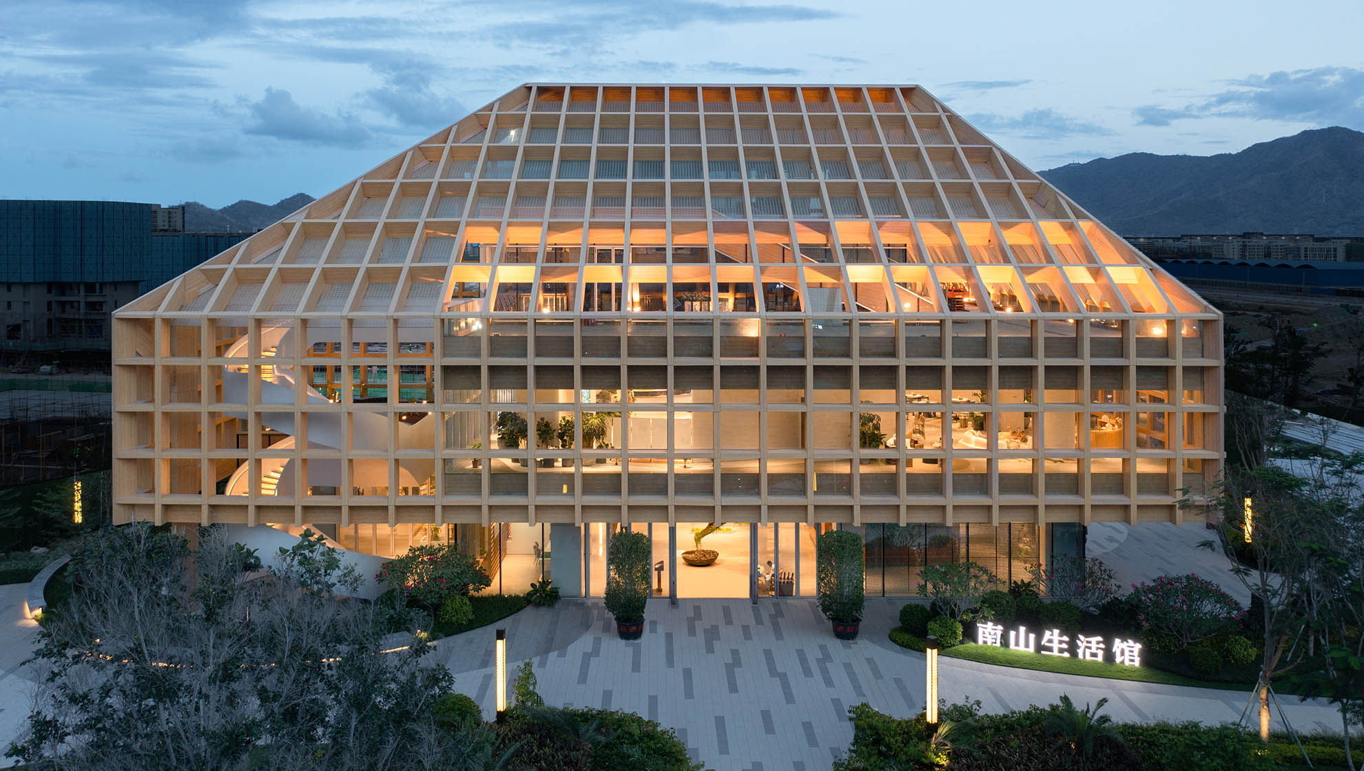 Exterior of Sanya Farm Lab featuring a wooden grid structure, blending technology and tradition to create a sustainable, climate-responsive building.