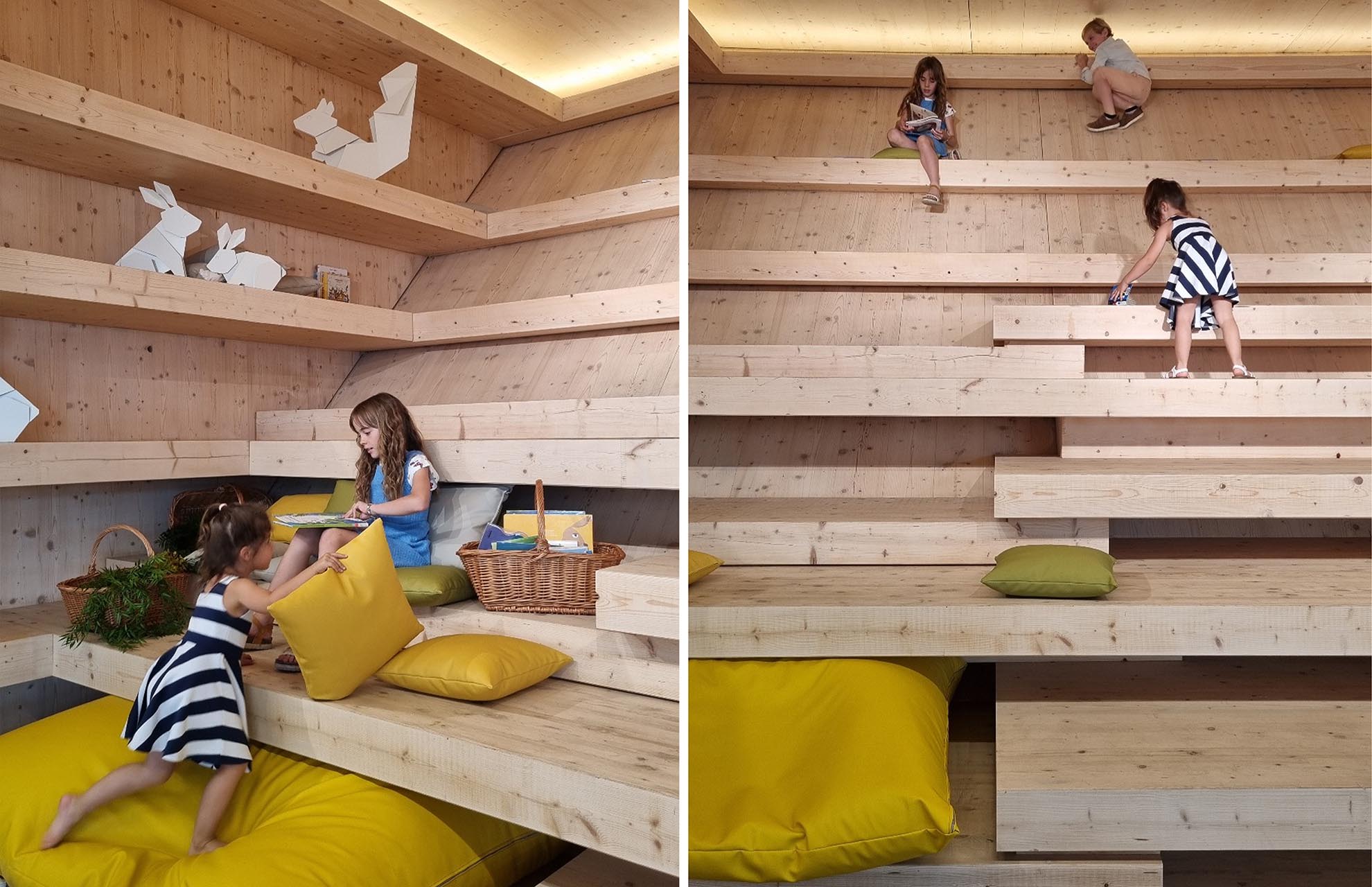 Play and reading area for children in the Gabriel García Márquez public library in Barcelona, with wooden furniture.