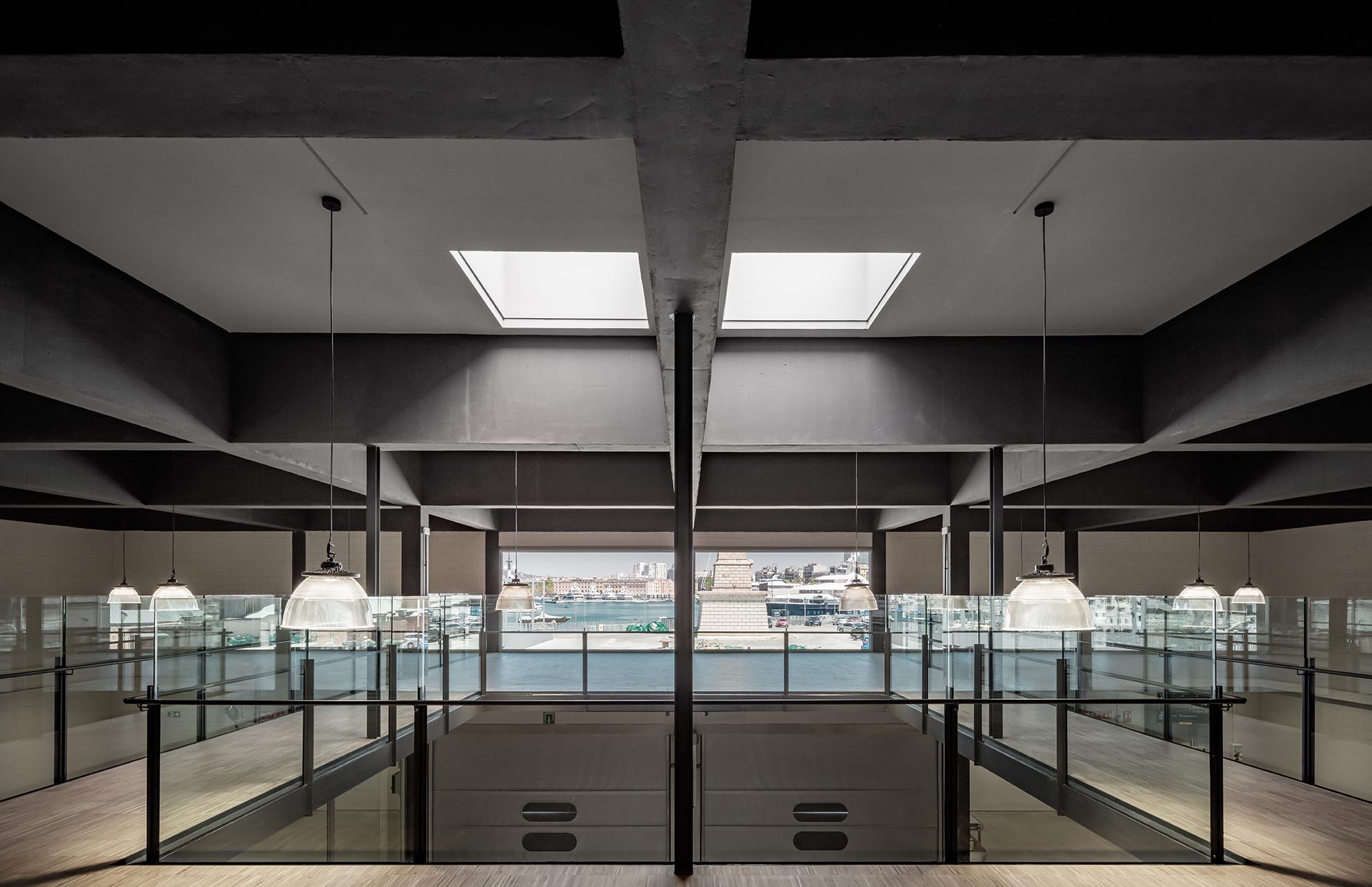 Interior of the Fish Market with skylights and sea views, demonstrating sustainable architecture and efficient natural lighting.