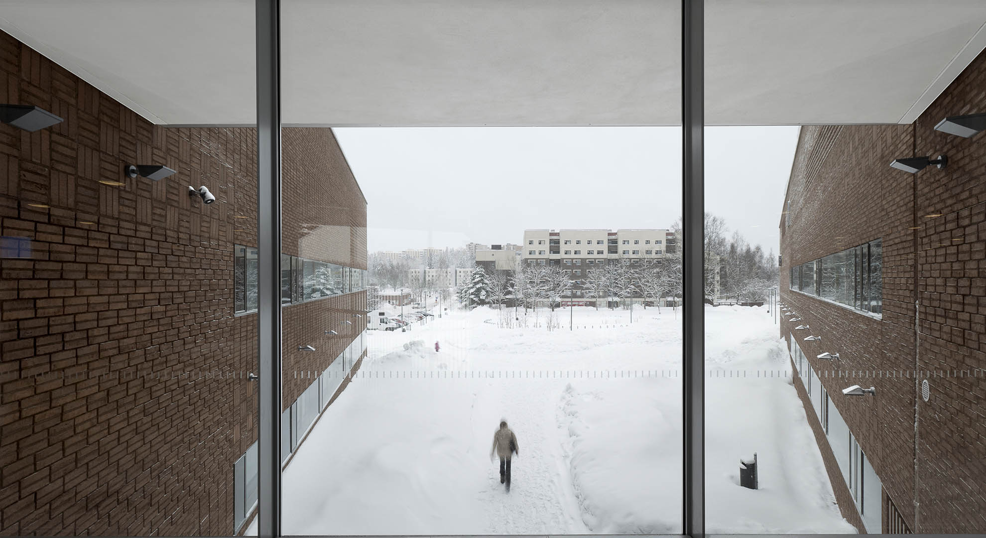 VIEW FROM THE KIRKKOJÄRVI SCHOOL TOWARDS THE HOUSING BLOCKS SEPARATED BY WOODS AND PARKING LOTS, ESPOO, 2010, VERSTAS ARCHITECTS. PHOTO © TUOMAS UUSHEIMO