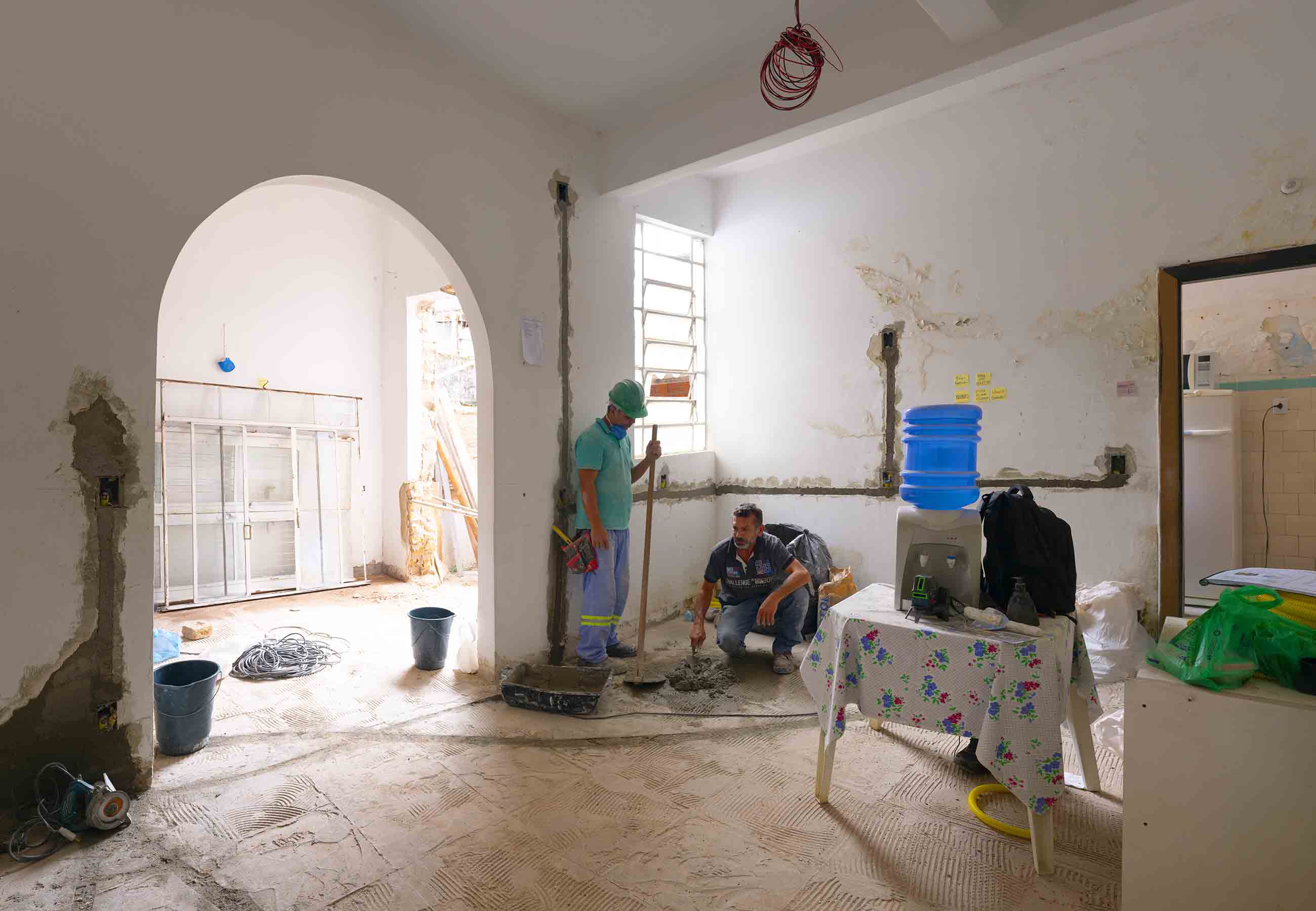 Workers renovating a home to provide dignified housing for the community