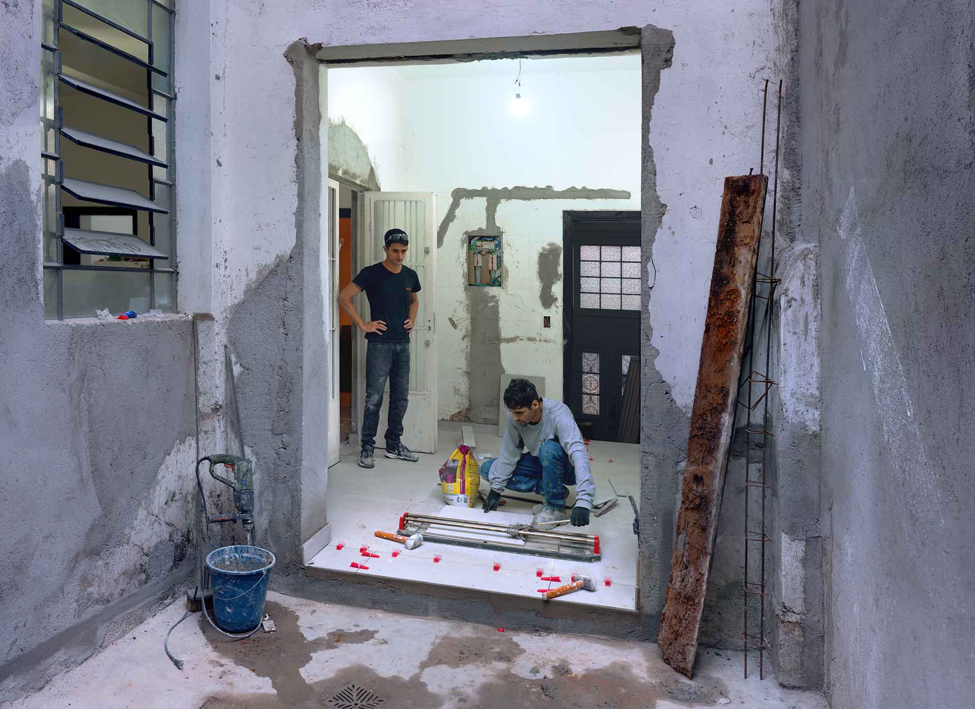 Local workers helping transform the space into dignified housing